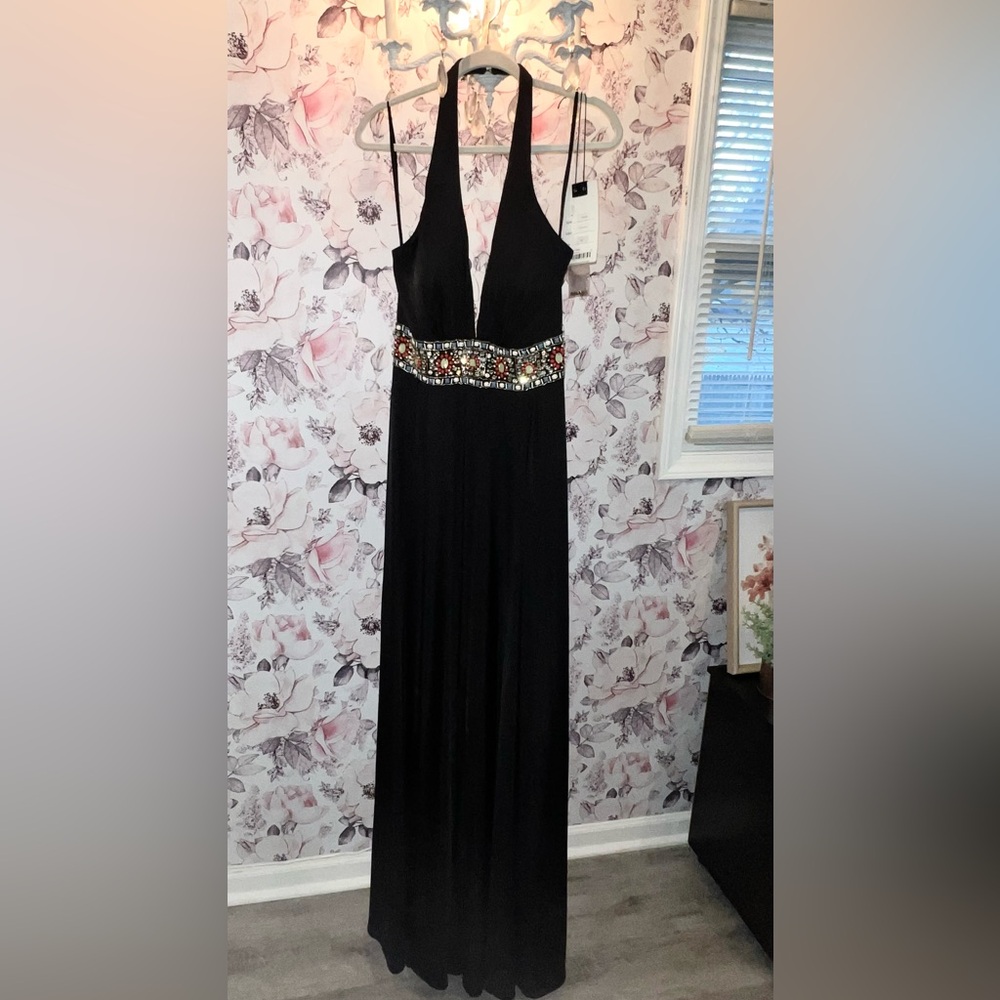 Beautiful black halter style jumpsuit, beaded belt line, open back, zipper back